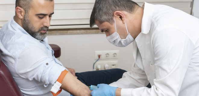 Doctor injecting into patient arm