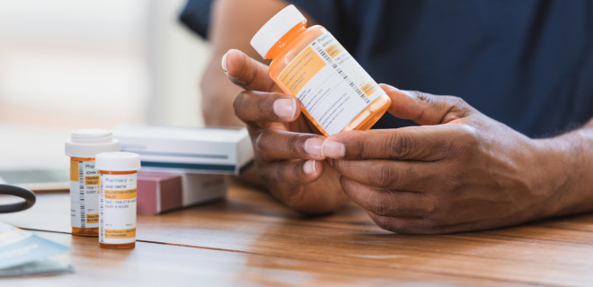 Bottle of pills in hand