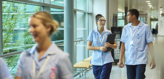 Healthcare professionals walking along corridor