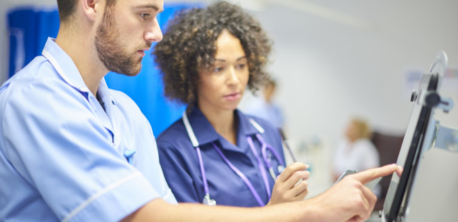 Healthcare professionals talking at screen