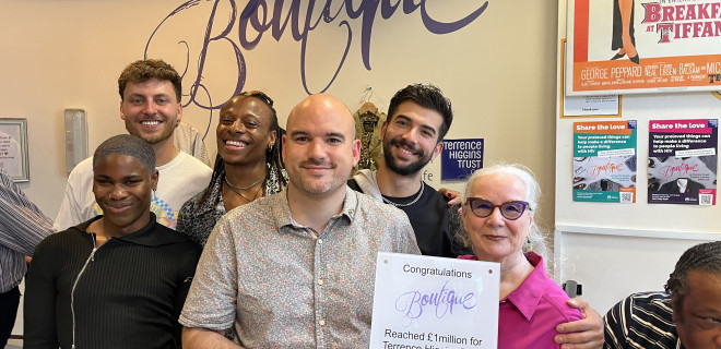 Boutique raises £1m. Chief Executive Richard Angell holds a sign congratulating the boutique with the cast of I Kissed A Boy.