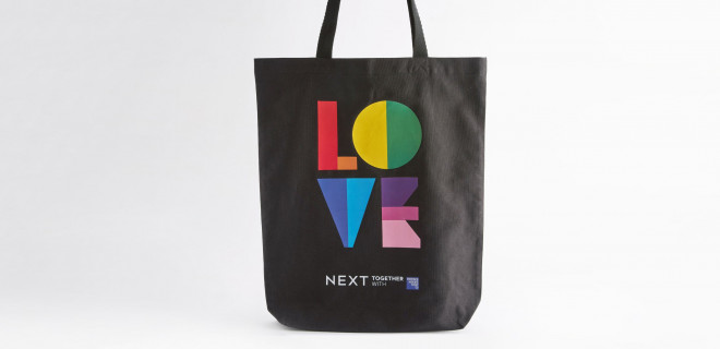 Tote bag with love written on it in pride flag colours