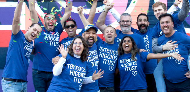Terrence Higgins Trust celebrating group in front of wall