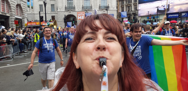 Woman blowing whistle at London Pride