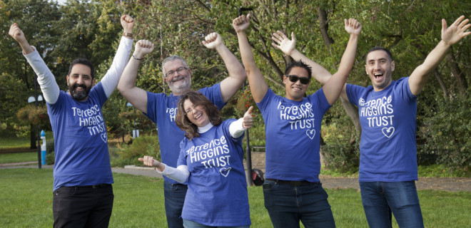 Group posing in THT shirts in a park