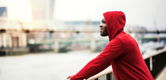 Sporty person looking out across river