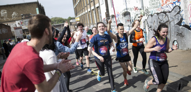 Runners in the Hackney Half Marathon being cheered on