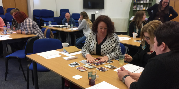 People sitting round tables during a training session.