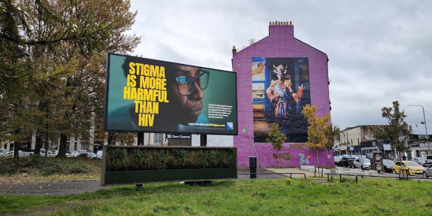 An outoodr digital billboard next to a house showing our anti-stigma messaging.