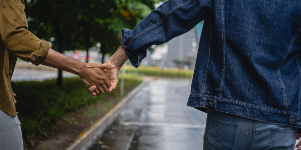 Two people holding hands