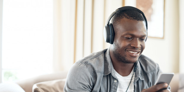 Man with headphones looking at his mobile phone