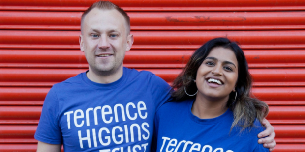 A man with his arm around a woman, both in Terrence Higgins Trust t-shirts.