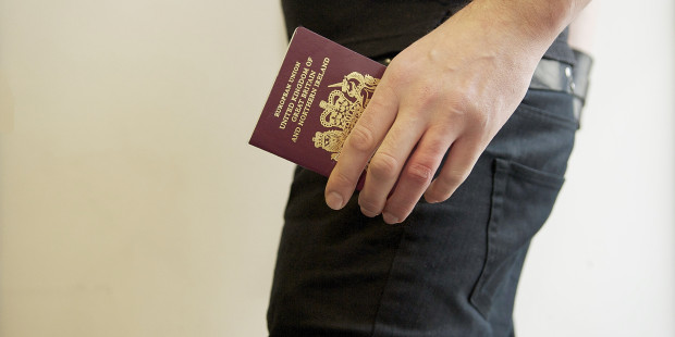 Man holding UK passport