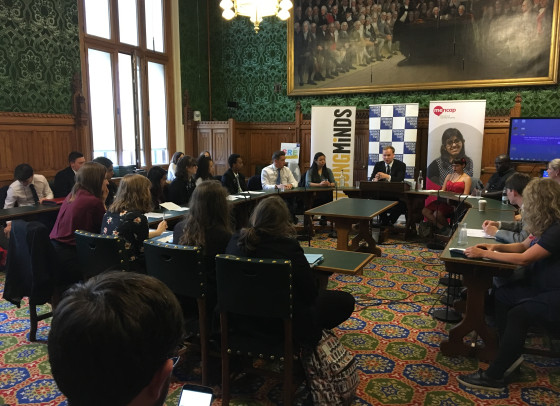 People sitting and listening to a speaker in a room in Parliament