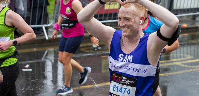 Marathon runner Sam in Terrence Higgins Trust T-shirt, making heart with hands